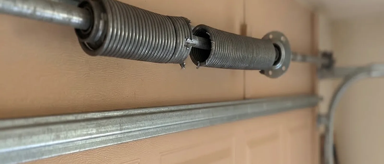 Broken torsion spring above a garage door in Martin